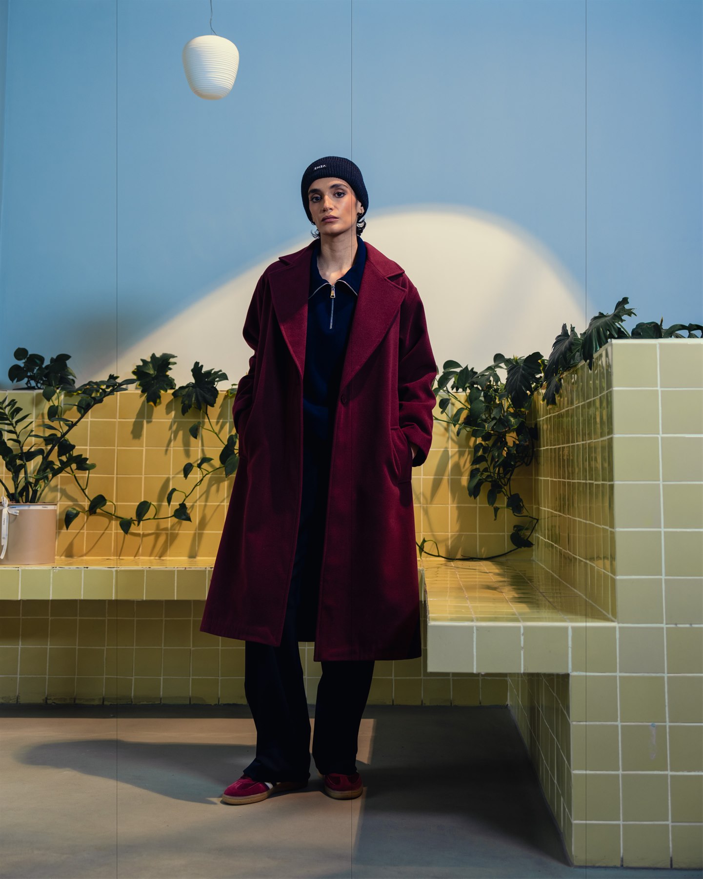 Model wearing a burgundy long coat